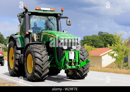 Kimito, Finland. July 6, 2019. Modern John Deere 8245R tractor on Kimito Tractorkavalkad, annual vintage tractor show and parade through community. Stock Photo