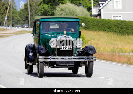 Finland. July 6, 2019. Kimito Tractorkavalkad 2019, vintage tractor parade featured also antique cars, here green Ford Model A on the road. Stock Photo