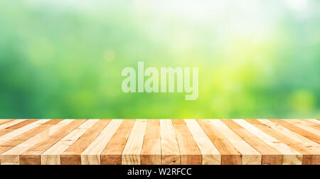 Real wood table top texture on blur fresh green garden background.For create product display or design key visual layout Stock Photo