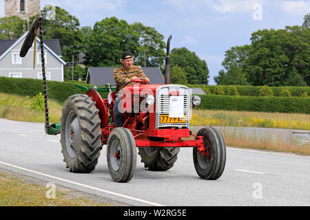 Kimito,Finland. July 6, 2019. Man drives Valmet 361 D tractor, year 1962, in front of farm equipment on Kimito Tractorkavalkad, vintage tractor parade Stock Photo