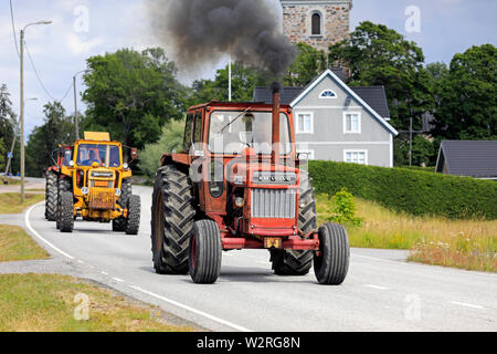 Kimito, Finland. July 6, 2019. Volvo BM tractors, red 810 first, on Kimito Tractorkavalkad, annual tractor parade through the small town. Stock Photo