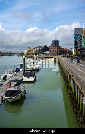 Littlehampton West Sussex UK - Homes overlooking the River Arun harbour with the old Look & Sea Centre in background Stock Photo