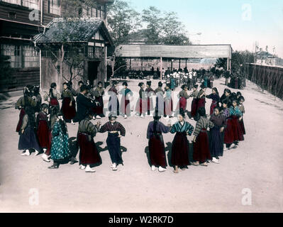 [ 1900s Japan - Female Elementary School Students ] —   Japanese elementary school students dancing in the school yard.  This image is part of 'The School Life of Young Japan,' a series published by Japanese photographer Kozaburo Tamamura in the early 1900s (late Meiji).  20th century vintage glass slide. Stock Photo