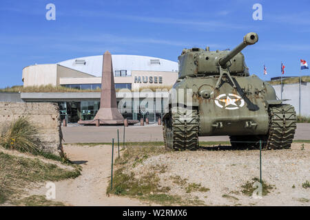 American M4 Sherman tank in front of the Musée du Débarquement Utah Beach, World War Two museum at Sainte-Marie-du-Mont, Normandy, France Stock Photo