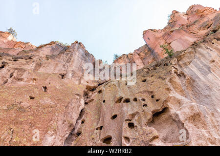 Park with low angle view of cliff canyon on Main Loop trail path in Bandelier National Monument in New Mexico Stock Photo