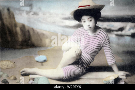 [ 1900s Japan - Japanese Woman in Bathing Suit ] —   A studio photo of a young woman with traditional hair style posing in a bathing suit. Models for these kind of photos were almost always geisha.  20th century vintage postcard. Stock Photo