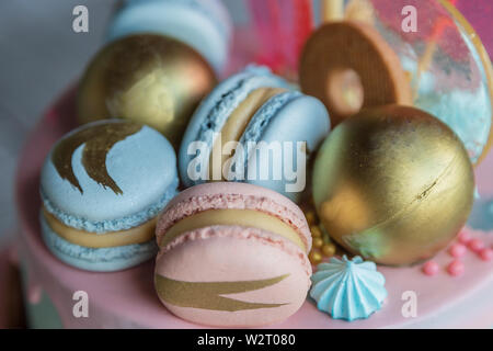 Colourful Fresh Macaroons on pastel cake in many levels on natural wooden background. Sweets concept. Stock Photo