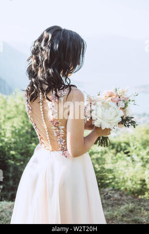 Close-up bride holds in hands a beautiful wedding bouquet. Wedding celebration. Stock Photo