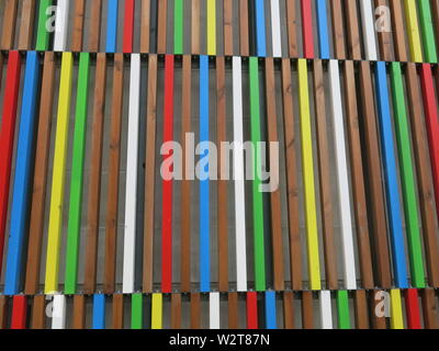 Close-up of the multi-coloured stripes in rows of cladding on the wall of a modern building in the redeveloped Leeds Docks area Stock Photo