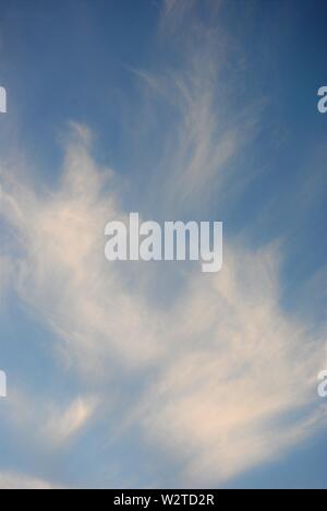 Abstract pattern of white wispy clouds in a blue sky. Stock Photo