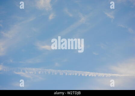 Abstract pattern of white wispy clouds in a blue sky. Stock Photo