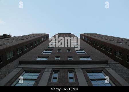 Low angle upshot of a tall architecture with blue sky in the background in Gramercy Park, NY Stock Photo