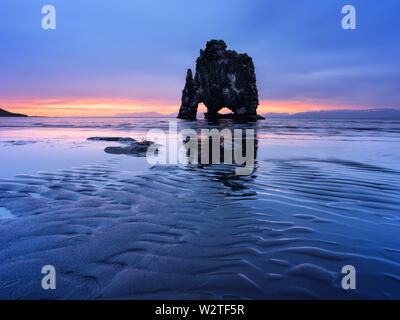 Hvitserkur cliff on the ocean coast in Iceland. Beautiful landscape with the ebb of the water and views of the rising sun Stock Photo