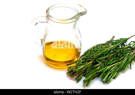 Olive oil in a jug and a branch of rosemary isolated on white Stock Photo