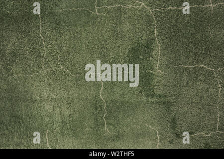 Wall image of rough texture with abundant cracks painted dark green Stock Photo