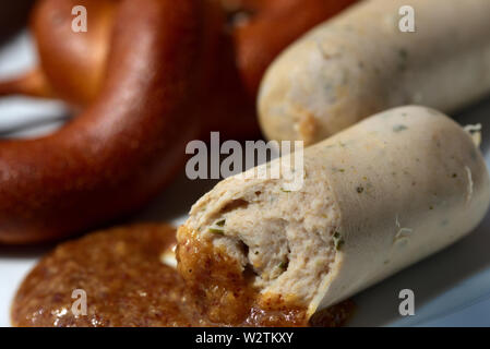 Fresh bavarian white sausages with pretzel on a plate Stock Photo