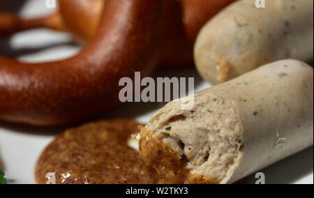 Fresh bavarian white sausages with pretzel on a plate Stock Photo