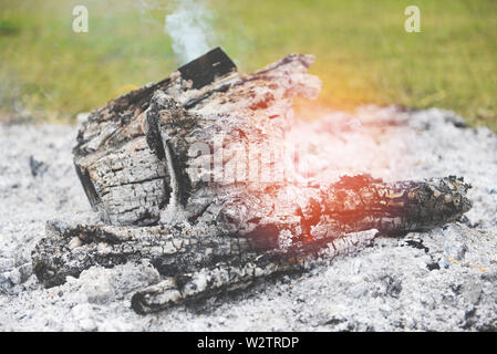 ash bonfire campfire wood burning charcoal and smoke on outdoors , selective focus Stock Photo