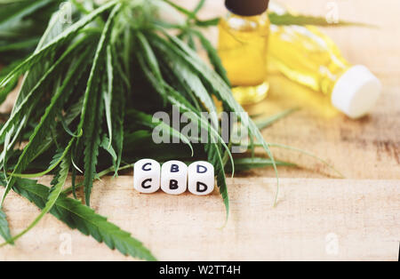 Cannabis oil in bottle / CBD oil extract from cannabis leaf Marijuana leaves for Hemp medical healthcare natural selective focus Stock Photo