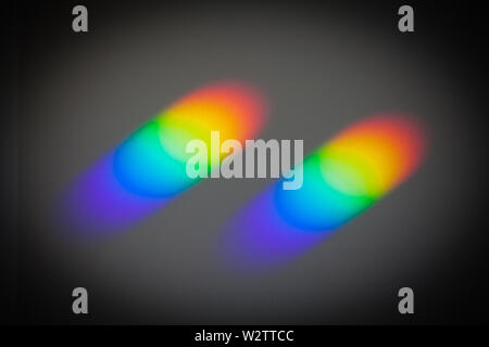 Rainbow Colours on the ceiling, caused by sunlight passing through small prisms on the windowsill. "Colour & Texture". The prisms come from binoculars Stock Photo