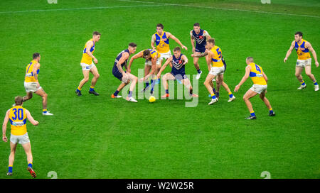 West Coast Eagles and Fremantle Dockers football players in Western Derby AFL game at Optus Stadium Perth Western Australia. Stock Photo