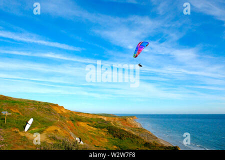 Hang Gliding over Compton Bay cliff tops at Compton Chine on the Isle of Wight Stock Photo