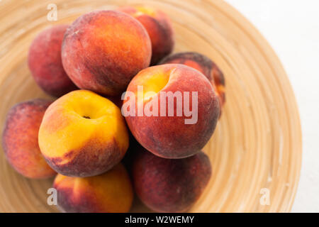 Fresh Ripe Peaches on a Plate, View from Above Stock Photo