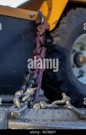 A chain holding on a vehicle in place Stock Photo
