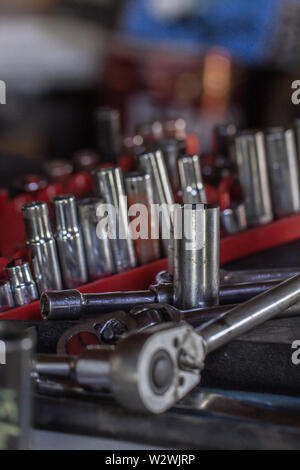 A bunch of wrench sockets on a work bench Stock Photo