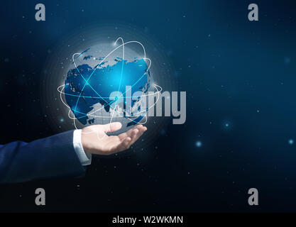 Male hand with digital model of Earth on dark background Stock Photo