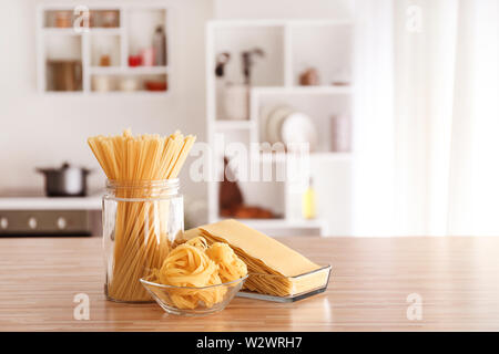 Uncooked pasta on table in kitchen Stock Photo