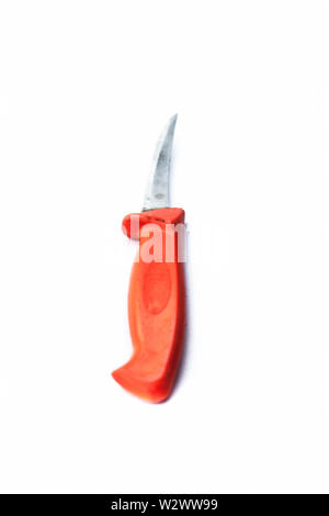 Close up of table knife or steak knife isolated on white with a orange colored handle. Stock Photo