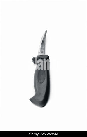 Close up of table knife or steak knife isolated on white with a orange colored handle. Stock Photo
