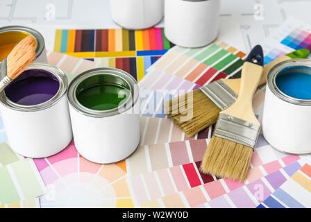 Cans of paint with brushes and palette samples Stock Photo
