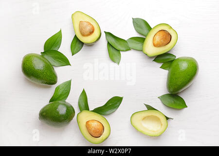 Frame made of fresh ripe avocados on white background Stock Photo