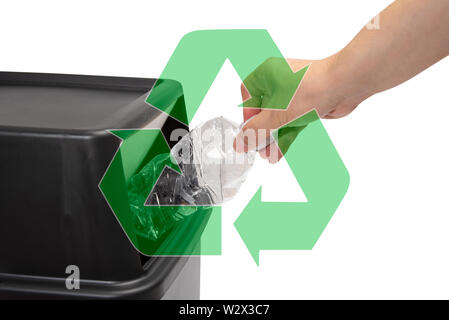 The hand of a man who throws a plastic bottle into a trash can. waste ...