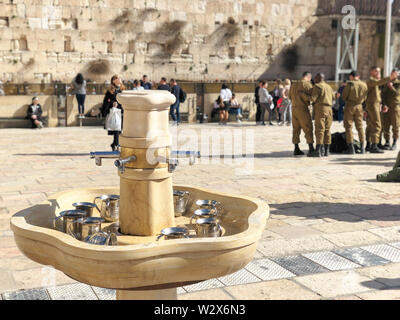 JERUSALEM, ISRAEL - JANUARY 22, 2019: Cranes with water and special ritual Cups for washing hands beside the Wailing Western Wall in Jerusalem Stock Photo