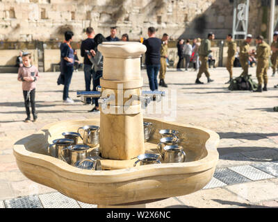 JERUSALEM, ISRAEL - JANUARY 22, 2019: Cranes with water and special ritual Cups for washing hands beside the Wailing Western Wall in Jerusalem Stock Photo