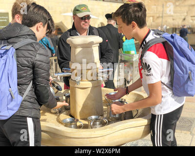 JERUSALEM, ISRAEL - JANUARY 22, 2019: Cranes with water and special ritual Cups for washing hands beside the Wailing Western Wall in Jerusalem Stock Photo