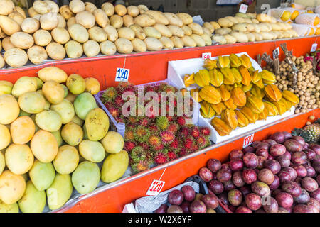 Fresh rambutan fruit bunch on local market in Thailand. Traditional asian fresh fruits. Stock Photo