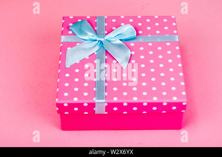 Square box of pink polka dots on bright background Stock Photo