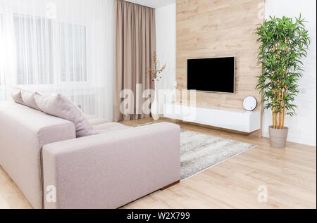 Living room with couch and led tv on wooden wall in modern interior Stock Photo