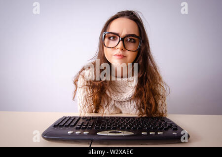 The funny nerd girl working on computer Stock Photo