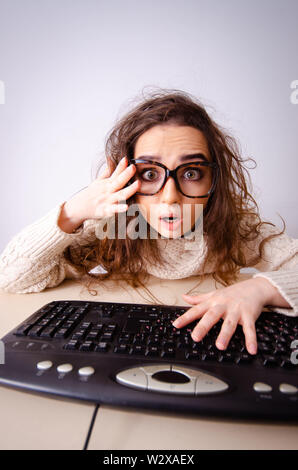 The funny nerd girl working on computer Stock Photo