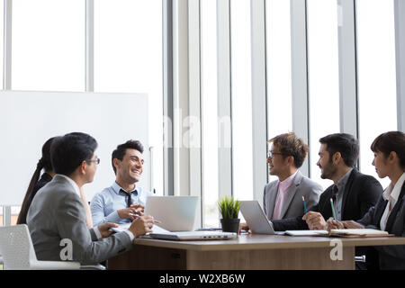 Annual sales summary meeting with the chiefs, secretary, translator and employees from various departments joining in the company, International commu Stock Photo