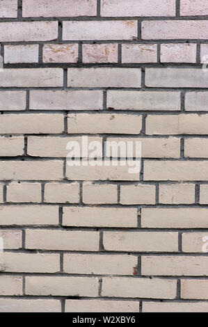 Old painted beige color weathered stained brick wall for texture or background Stock Photo