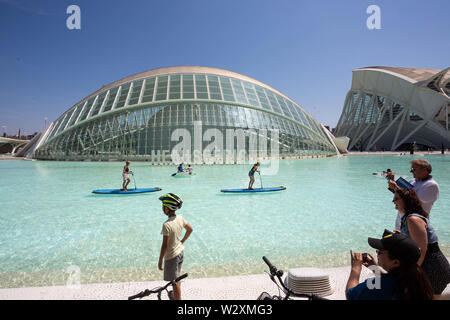 Valencia, Valencia, Spain. 10th June, 2019. People enjoy on the lake in front of Hemisferic cinema at the arts & science city in Valencia.Arts and Science City is an entertainment-based cultural, sci-fi-style and architectural complex in the city of Valencia, Spain. It is the most important modern tourist destination in the city of Valencia. Designed by Santiago Calatrava and Félix Candela, the project began the first stages of construction in July 1996, and was inaugurated April 16, 1998 with the opening of L'HemisfÃ¨ric. The last great component of the City of Arts and Sciences, El Palau d Stock Photo