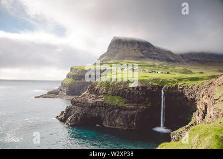 Gasadalur village and Beautiful waterfall. Vagar, Faroe Islands, Denmark Stock Photo