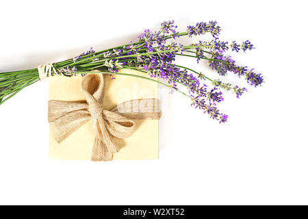 Beauty setting with lavender flowers and gift box natural color with bow on white background, isolated. Stock Photo