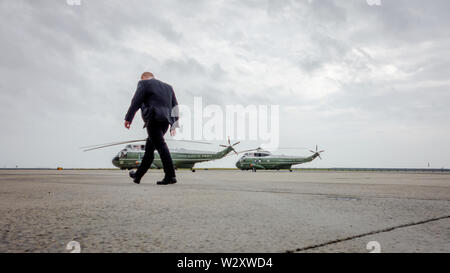 A Secret Service agent walks past the two Sikorsky SH-3 Sea King helicopters, one of which to be used by the US President and designated call sign 'Marine One'. US President Barack Obama is en route on Air Force One to New York to attend several fund raisers for his re-election campaign. Stock Photo